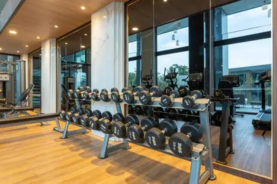 a gym with rows of dumbbells in a house at Sea View 1-BR 36 m2 Panora Surin by Holy Cow in Surin Beach