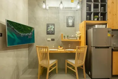 a kitchen with a table and two chairs and a refrigerator at Relife Windy by Holy Cow, studio with stunning country view in Nai Harn Beach