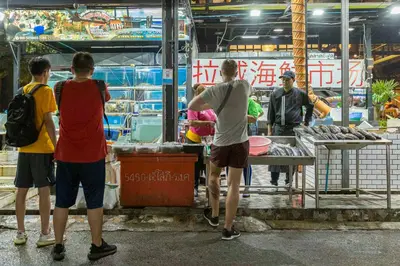 a group of people standing around a food truck at Relife Windy by Holy Cow, studio with stunning country view in Nai Harn Beach