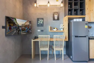 a kitchen with a table with two chairs and a refrigerator at Relife Windy by Holy Cow, studio with stunning country view in Nai Harn Beach