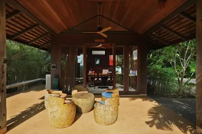 a living room with chairs and a ceiling fan at SAMSAM Yao Noi - ANDAMAN MAGIC & ART VILLAS in Ko Yao Noi