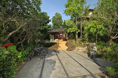 a house with a statue in the middle of a driveway at SAMSAM Yao Noi - ANDAMAN MAGIC & ART VILLAS in Ko Yao Noi