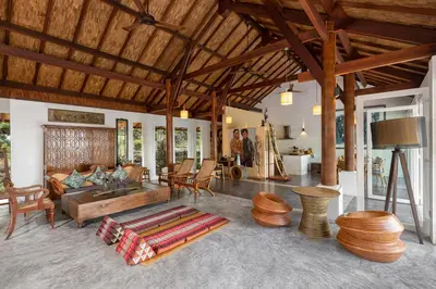a living room with a couch and a table at SAMSAM Yao Noi - ANDAMAN MAGIC & ART VILLAS in Ko Yao Noi