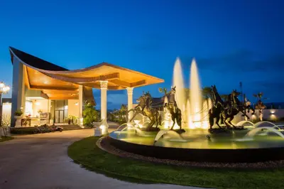 a fountain with horses in front of a building at Gold Chariot Pool Villa, Phuket - SHA Plus Certified in Bang Tao Beach