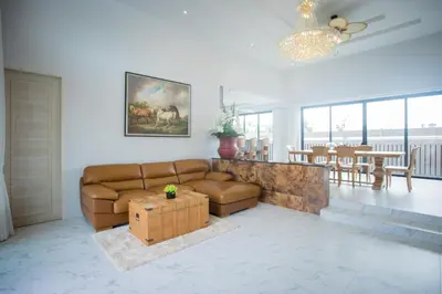 a living room with a couch and a table at Gold Chariot Pool Villa, Phuket - SHA Plus Certified in Bang Tao Beach