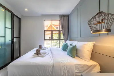 a bedroom with a white bed with a window at 1BDR Apartment near Surin beach #210 in Surin Beach