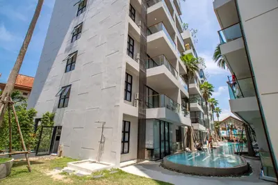 an apartment building with a swimming pool and palm trees at 1BDR Apartment near Surin beach #210 in Surin Beach