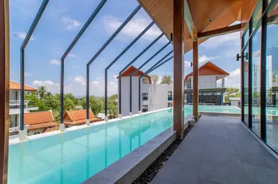 a swimming pool with a view of a building at 1BDR Apartment near Surin beach #210 in Surin Beach