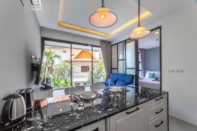 a kitchen with a counter with wine glasses on it at 1BDR Apartment near Surin beach #210 in Surin Beach