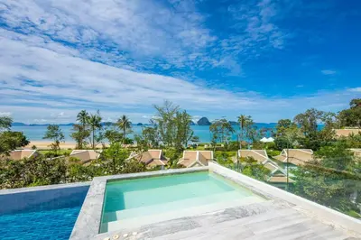 a swimming pool with a view of the ocean at Banyan Tree Krabi in Tab Kaek Beach
