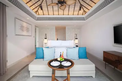a living room with a couch and a tv at Banyan Tree Krabi in Tab Kaek Beach