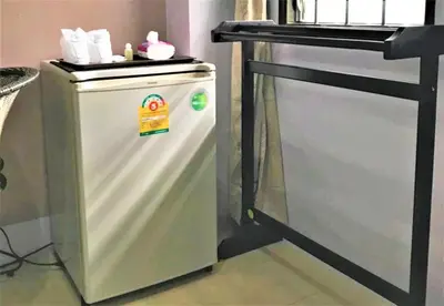 a small refrigerator with a counter on top of it at Nasa Hotel in Phuket Town