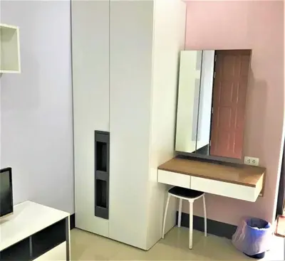 a dressing room with a mirror and a sink at Nasa Hotel in Phuket Town