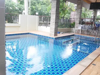 a swimming pool with blue tiles in a building at Nasa Hotel in Phuket Town