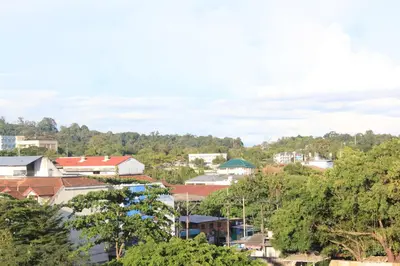 a view of a city with trees and buildings at Lub Sbuy House Hotel - SHA in Phuket Town