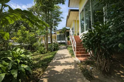 a house with a walkway leading to the front door at Phi Phi Chang Grand Resort in Phi Phi Don