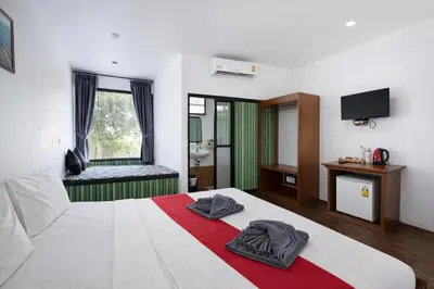 a bedroom with a bed with two towels on it at Phi Phi Chang Grand Resort in Phi Phi Don
