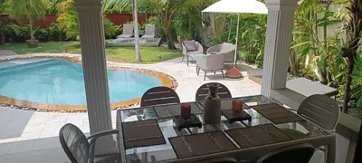 a patio with a table and chairs next to a swimming pool at Villa Paradise Island in Rawai Beach
