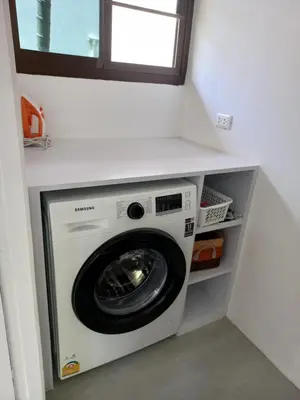 a washing machine in a laundry room with a window at Villa Paradise Island in Rawai Beach