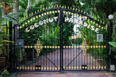 a black wrought iron gate with a sign on it at Villa Paradise Island in Rawai Beach