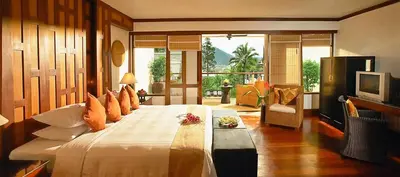 a bedroom with a large bed with a television at Baan Yin Dee Boutique Resort Phuket - SHA Plus in Patong Beach