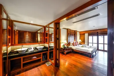 a large room with a bed and a bathroom at Baan Yin Dee Boutique Resort Phuket - SHA Plus in Patong Beach