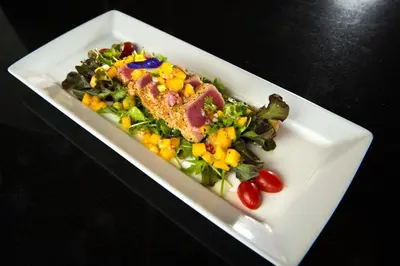 a plate of food with a salad on a table at Baan Yin Dee Boutique Resort Phuket - SHA Plus in Patong Beach