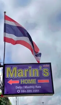 a flag flying over a marlin store with a sign at Marin' s Home in Thalang