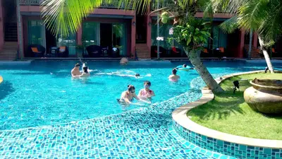 a group of people swimming in a swimming pool at Mai Morn Resort SHA Plus in Phuket Town