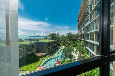 a view of a swimming pool from a hotel window at Panora sea view -modern facilities walk to beach in Surin Beach