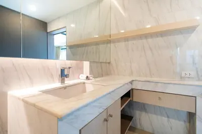 a bathroom with a sink and a mirror at Panora sea view -modern facilities walk to beach in Surin Beach