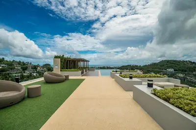 a view from the roof of a building with grass and benches at Panora sea view -modern facilities walk to beach in Surin Beach