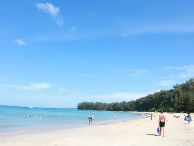 a group of people on a beach in the water at Title Residence Naiyang Beach Phuket in Nai Yang Beach
