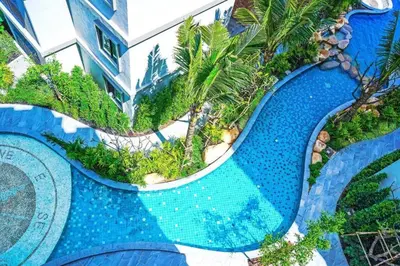 an aerial view of a swimming pool at a resort at Title Residence Naiyang Beach Phuket in Nai Yang Beach