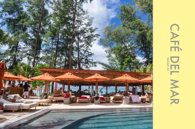 a swimming pool with chairs and umbrellas at Stylish Condo w. Pool View 2F in Kamala Beach