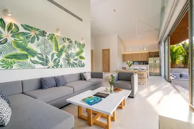 a living room with a couch and a table at Himmapana Villas - Terraces - SHA Extra Plus in Kamala Beach