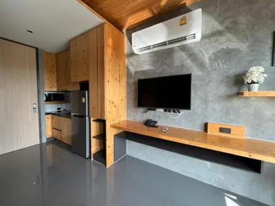 a kitchen with a counter with a tv and a refrigerator at Relife The Windy by VillaCarte in Rawai Beach