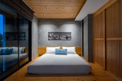 a bedroom with a large white bed in it at Relife The Windy by VillaCarte in Rawai Beach