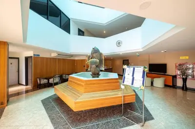 a lobby with a statue in the middle of a building at Mai Khao Beach Condo by VillaCarte in Mai Khao Beach