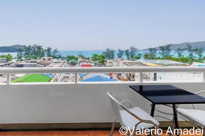 a balcony with a table and chairs and a view at Patong Tower Sea View by PHR in Patong Beach