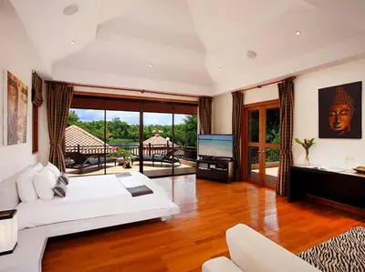 a living room with a white couch and a television at Laguna Waters in Phuket Town