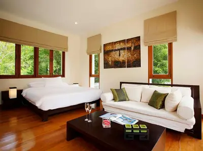 a large bedroom with a bed and a couch at Laguna Waters in Phuket Town