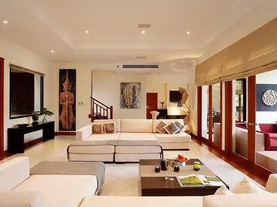 a living room with a couch and a table at Laguna Waters in Phuket Town