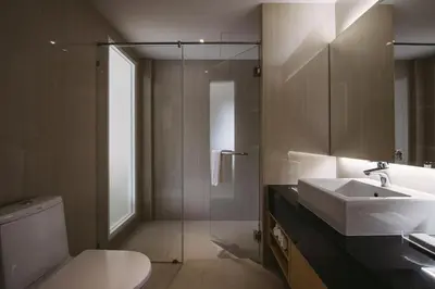 a bathroom with a sink and a toilet at TIRAS Patong Beach Hotel in Patong Beach