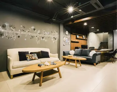 a living room with a couch and a table at TIRAS Patong Beach Hotel in Patong Beach