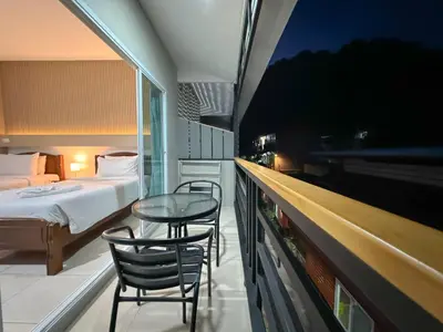 a room with a bed and a table and chairs at Chongkhao Resort- Phi Phi Island in Phi Phi Don