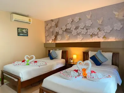 two beds in a hotel room with cakes on them at Chongkhao Resort- Phi Phi Island in Phi Phi Don