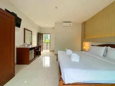 a bedroom with a large bed and a bathroom at Chongkhao Resort- Phi Phi Island in Phi Phi Don
