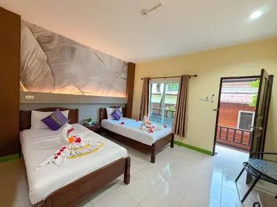 a bedroom with two beds and a balcony at Chongkhao Resort- Phi Phi Island in Phi Phi Don
