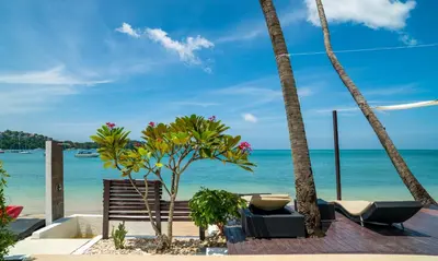 a view of the beach from a resort with palm trees at Dreambeach 2-villas in Panwa Beach